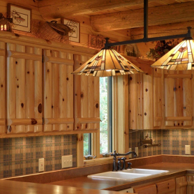 Knotty pine log upper cabinets, knotty pine log rafters, and knotty pine tongue and groove paneling
