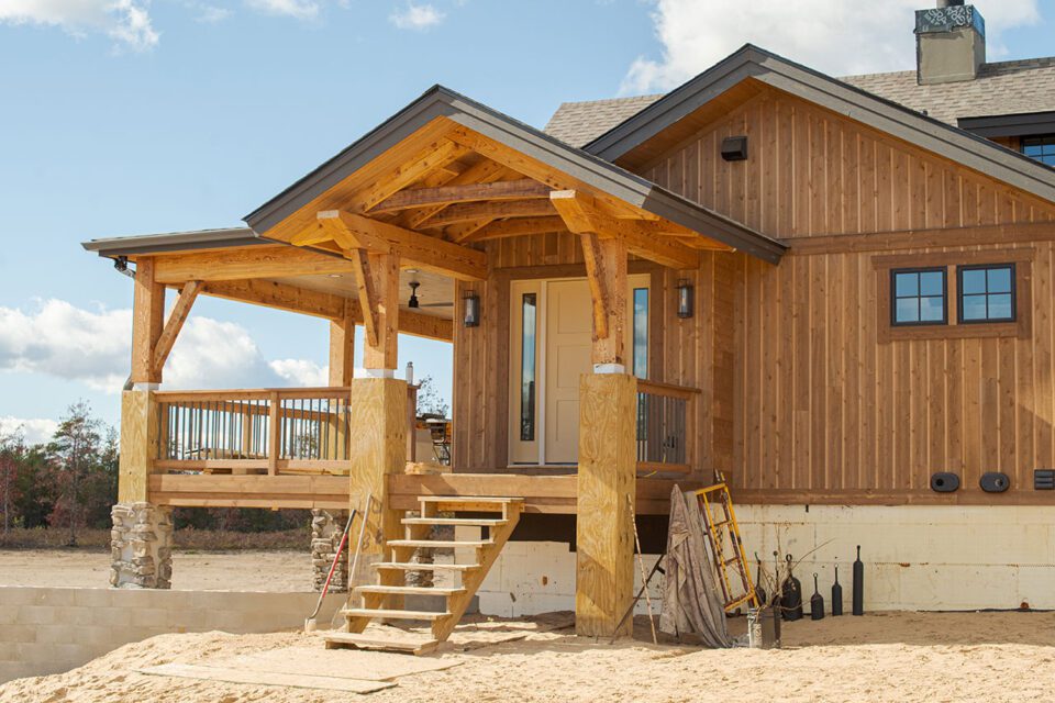A log home being built upon a concrete foundation