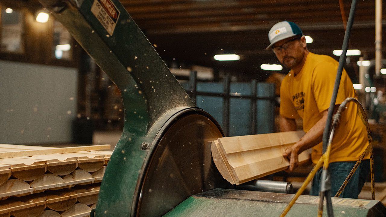 Hand hewning log siding