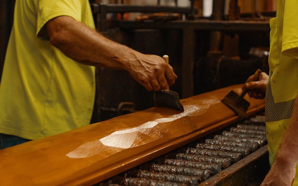 Prestaining hand hewn log siding
