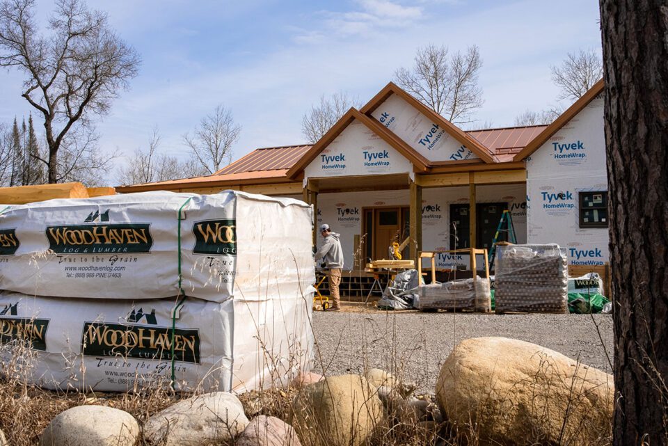 WoodHaven log siding ready to be installed onto this standard home frame