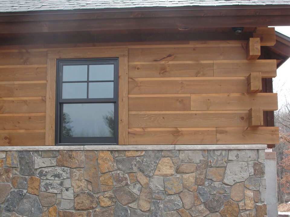 Combine Adirondack siding, butt-and-pass corners, rough sawn trim and stonework