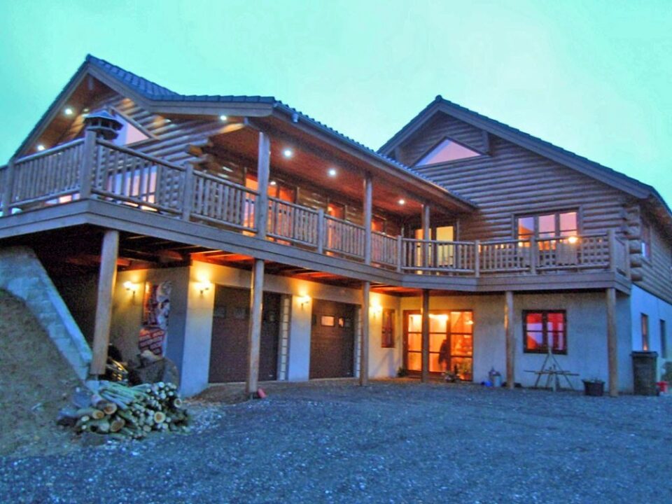 Cedar half log siding, cedar posts and railing, D trim and knotty pine paneling