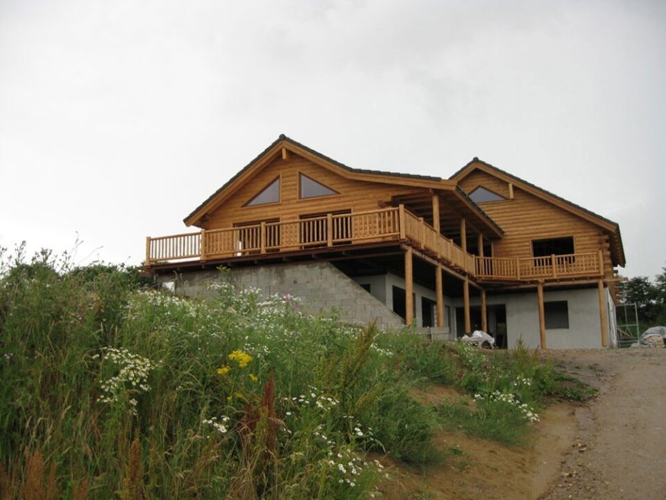 Cedar half log siding with cedar deck and railing
