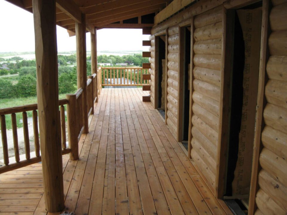 Half log siding, cedar porch and cedar deck railing