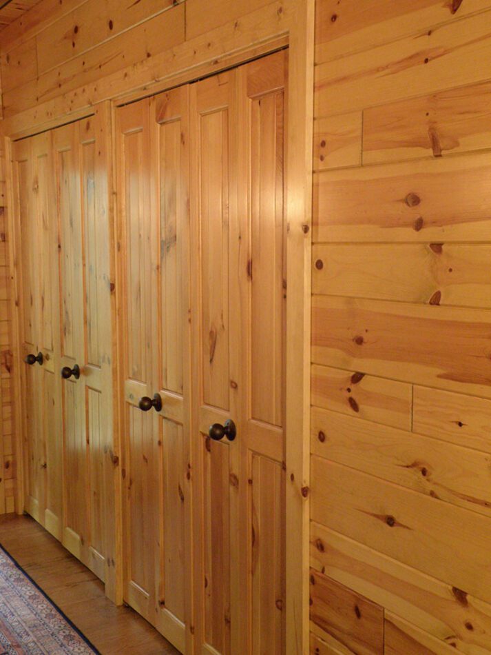 Bi-fold closet doors made with knotty pine paneling