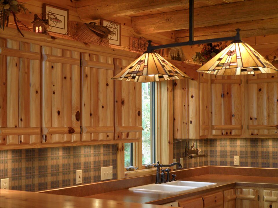 Knotty pine log upper cabinets, knotty pine log rafters, and knotty pine tongue and groove paneling