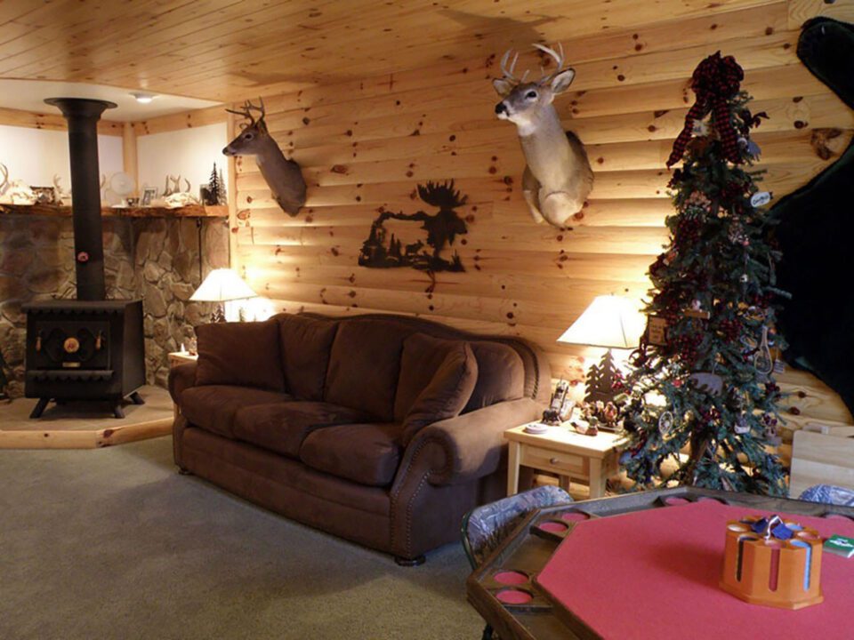 This basement was turned into the ultimate man cabin with WoodHaven log siding.