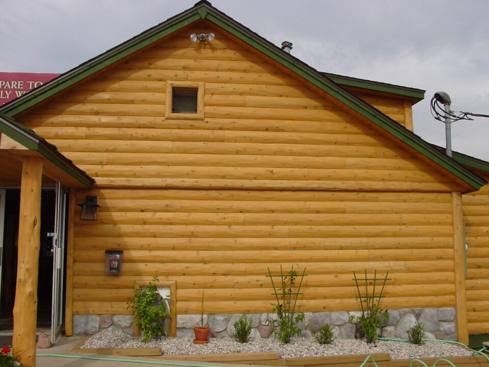 Commercial building with hewn half log siding